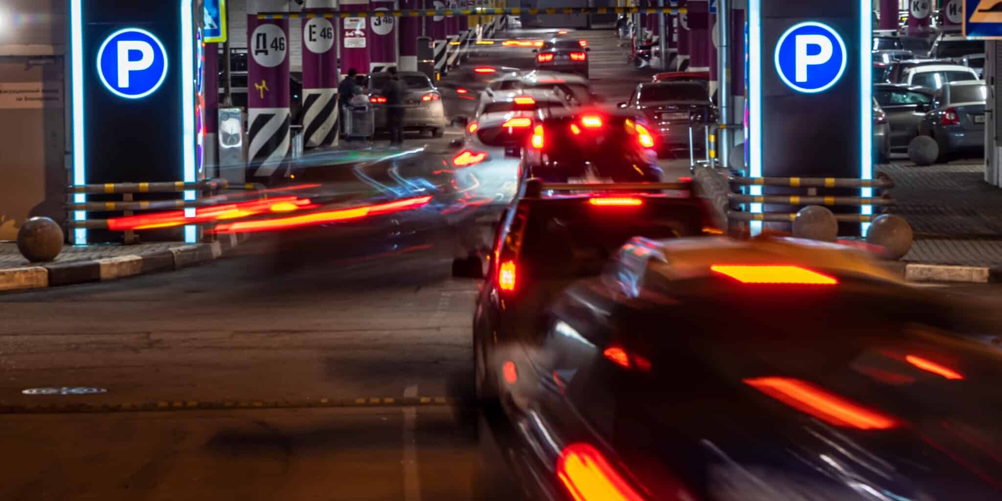 cars in queue at entrance in underground parking of hypermarket