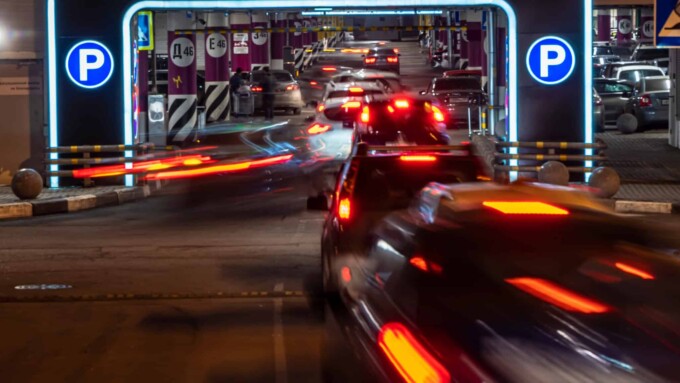 cars in queue at entrance in underground parking of hypermarket